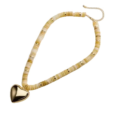 A beaded necklace featuring textured cream and pale yellow stone beads accented with small gold spacers, a gold heart-shaped pendant, and a gold chain extender, displayed on a light beige background.